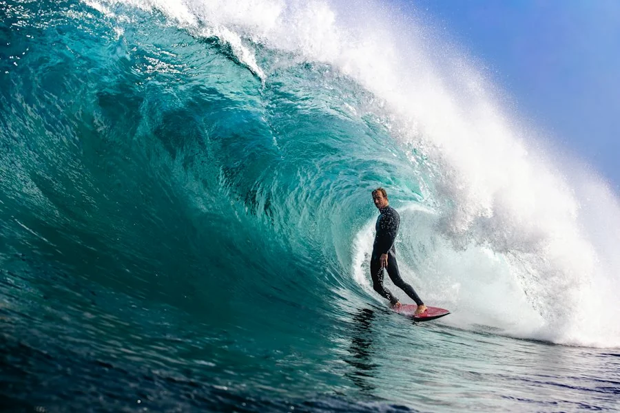 Surfer riding inside a big breaking wave